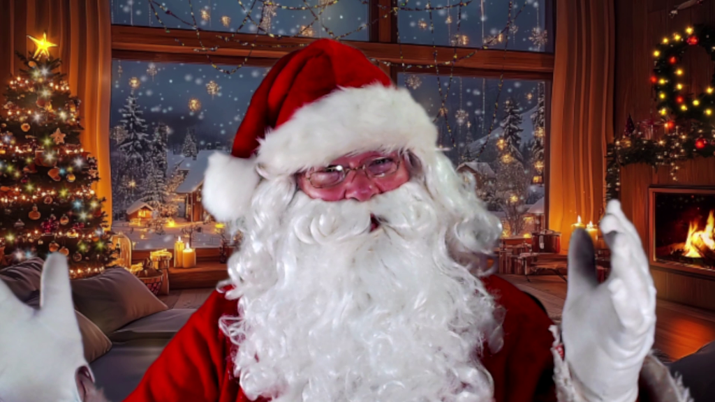 Santa Claus smiling in a cozy, festive room with a decorated Christmas tree, glowing fireplace, and snowy window view. The scene is warm and joyful.