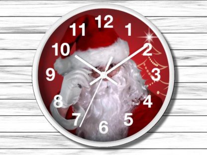 Clock with Santa in a red hat on the face, against a red background with a stylized Christmas tree. Wooden texture surrounds the clock.