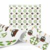 Christmas Wrapping paper with a festive pattern of green wreaths and red candles. A wrapped gift showcases the design, evoking a warm, holiday feeling.