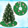 Green Christmas tree skirt featuring a pattern of red ornaments with Santa Claus faces. The design is festive and playful, evoking holiday cheer.
