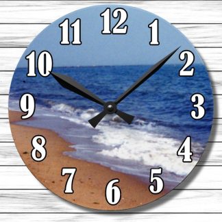Round clock with beach scene featuring sandy shore, gentle waves, and blue ocean. Black hands and bold numbers on a wooden background. Peaceful vibe.