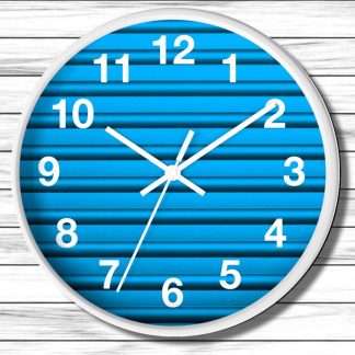 Wall clock with a white frame and bold white numerals on a blue striped background. The hands point to 10:10, conveying a clean, modern style.