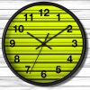 A round wall clock with a black rim features a vibrant yellow background with horizontal lines. It has bold black numbers and hands showing 10:09.
