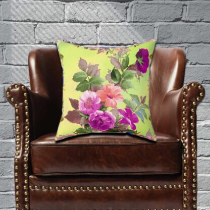 Floral pillow with pink, purple, and peach flowers, green leaves on a light yellow background. Elegant, vibrant, and refreshing design.