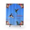A vibrant blue shower curtain features two hovering hummingbirds and a perched kingfisher. Colorful flowers adorn the top corners, evoking a lively, tropical feel.