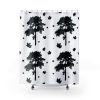 Shower curtain with a minimalist black and white design featuring silhouette images of trees and scattered maple leaves, creating a tranquil forest vibe.