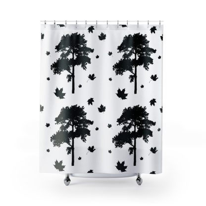 Shower curtain with a minimalist black and white design featuring silhouette images of trees and scattered maple leaves, creating a tranquil forest vibe.