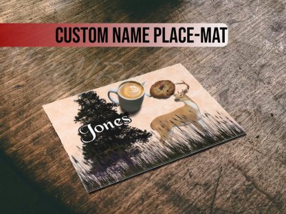 Cup of latte and a cookie on a placemat with an illustration of a deer and tree, text "Jones." Rustic wooden table, cozy and rustic feel.