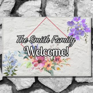 Welcome mat on a stone step with "Welcome" and "The Smith Family" text. Adorned with purple and pink flowers, evoking a warm, inviting tone.