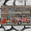 Welcome mat in a rustic wooden panel style on a gray stone step with "The Smith Family Welcome!" text. Features a vintage red truck, a glowing lantern, and autumn leaves, set against a rustic wooden panel design.