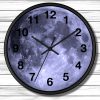 A round wall clock with a full moon face set against white wood panels. The clock hands point to 10:10, evoking a serene, celestial theme.