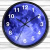 A round wall clock features a striking blue moon design, white numbers, and black hands, set against a wooden plank background, conveying a serene, cosmic vibe.