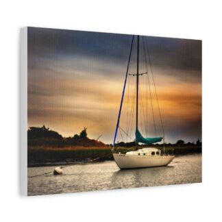A serene sailboat on calm water at sunset, with a vivid sky blending orange and blue hues.