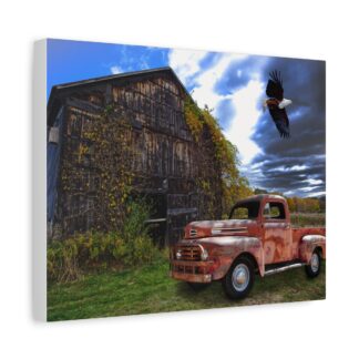 Canvas wall print of a rustic barn with overgrown vines and an old red truck sit under a dramatic cloudy sky, with an eagle soaring above. The scene feels nostalgic and serene.