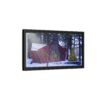 A framed canvas art on a wall shows a cozy cabin in winter, surrounded by snowy woods. A decorated Christmas tree and wreath add a festive touch.