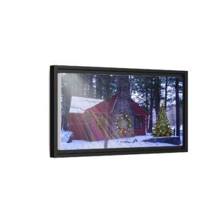A framed canvas art on a wall shows a cozy cabin in winter, surrounded by snowy woods. A decorated Christmas tree and wreath add a festive touch.