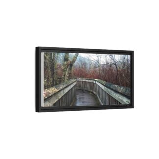 Framed canvas wall art of a wooden boardwalk curving through a misty, leafless forest with bare trees, creating a serene, introspective atmosphere.