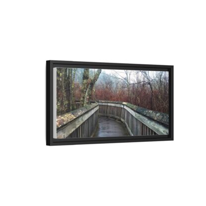 Framed canvas wall art of a wooden boardwalk curving through a misty, leafless forest with bare trees, creating a serene, introspective atmosphere.