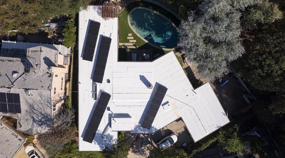 Close-up of EBA Roofing, Inc workers installing roofing materials on a residential home in Sherman Oaks, CA, highlighting their professionalism and quality workmanship.