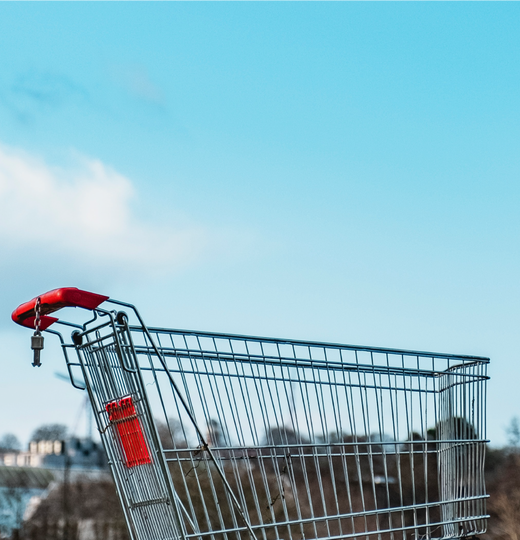 Blog header image with shopping cart outside with blue sky behind it