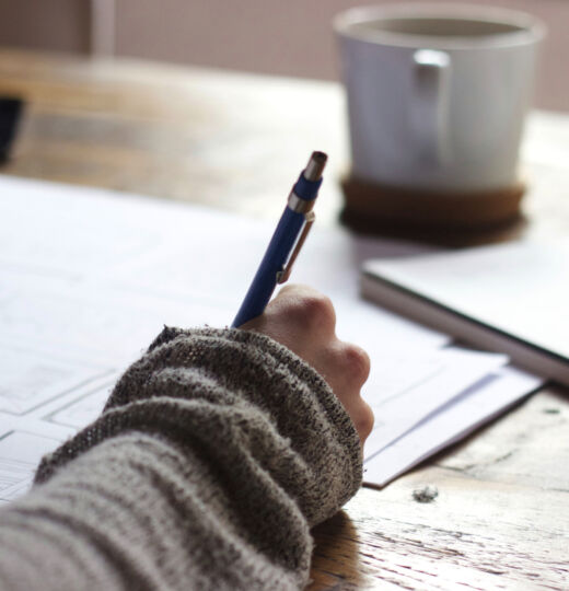 person writing at a desk