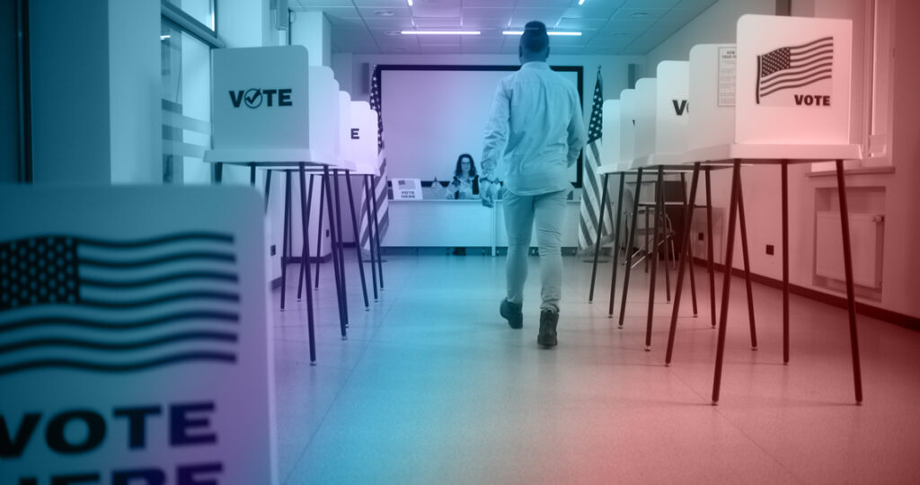 African American male voter walks to female polling officer at polling station