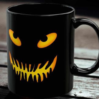 A black mug with a glowing, eerie jack o lantern face. The design features bright orange eyes and a sharp, jagged mouth, creating a spooky, Halloween vibe.