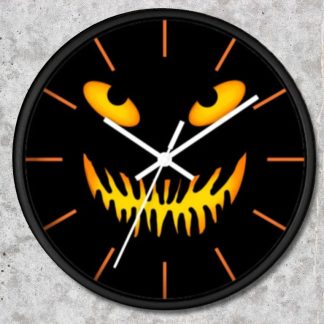 Black clock with a spooky yellow and orange jack-o'-lantern face, featuring glowing eyes and a jagged grin. White hands and orange hour marks. Halloween theme.