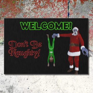 Welcome mat features a creepy Krampus in red Christmas Santa suit holds a child upside down next to green "WELCOME!" text against a black background. Red text reads "Don't Be Naughty!" on a cracked old cement step.