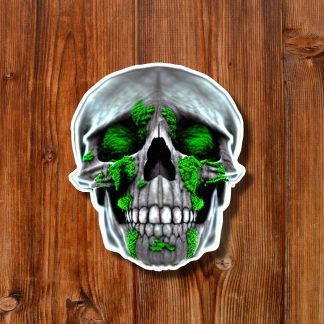 Sticker of a weathered skull covered in bright green moss, centered on a warm wooden plank background, creating an eerie natural tone.
