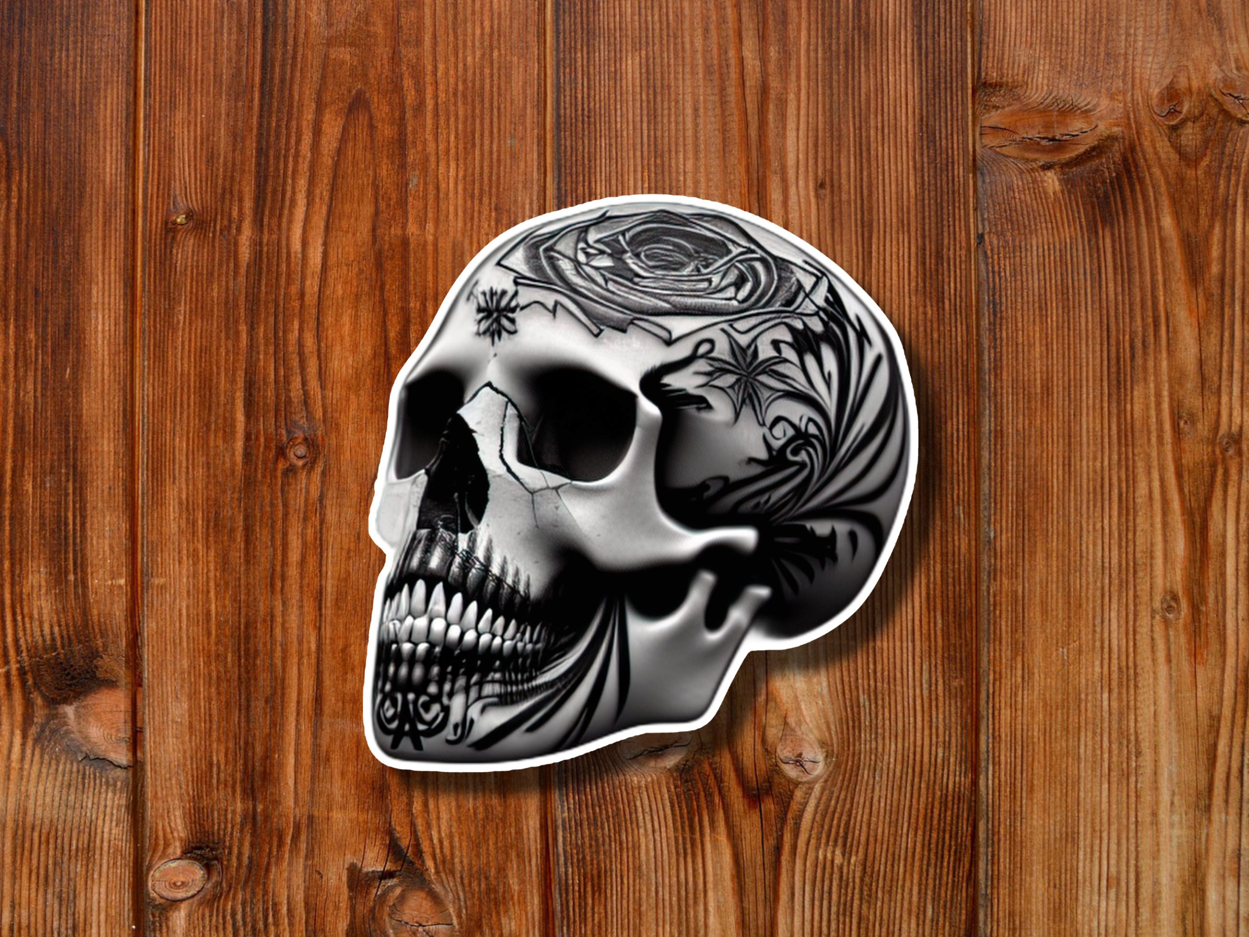 Black-and-white skull artwork with intricate rose and floral tattoos rests on a warm wooden plank background, creating a dark, edgy mood.