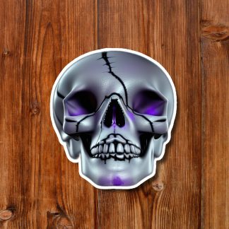 Stylized silver skull sticker with purple eye sockets rests on a warm, rustic wooden plank background, creating an eerie mood.