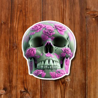 Decorative green skull adorned with pink roses on a rustic wooden background, creating a dramatic gothic and macabre yet floral design.