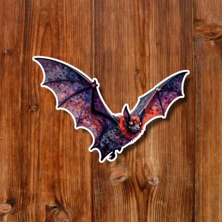 Colorful gothic bat sticker with purple-red patterned wings and orange face, centered on warm rustic wooden planks; playful spooky tone.