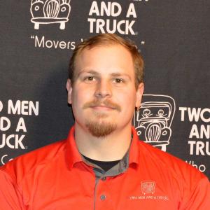 headshot of ferris owens with two men and a truck branded background