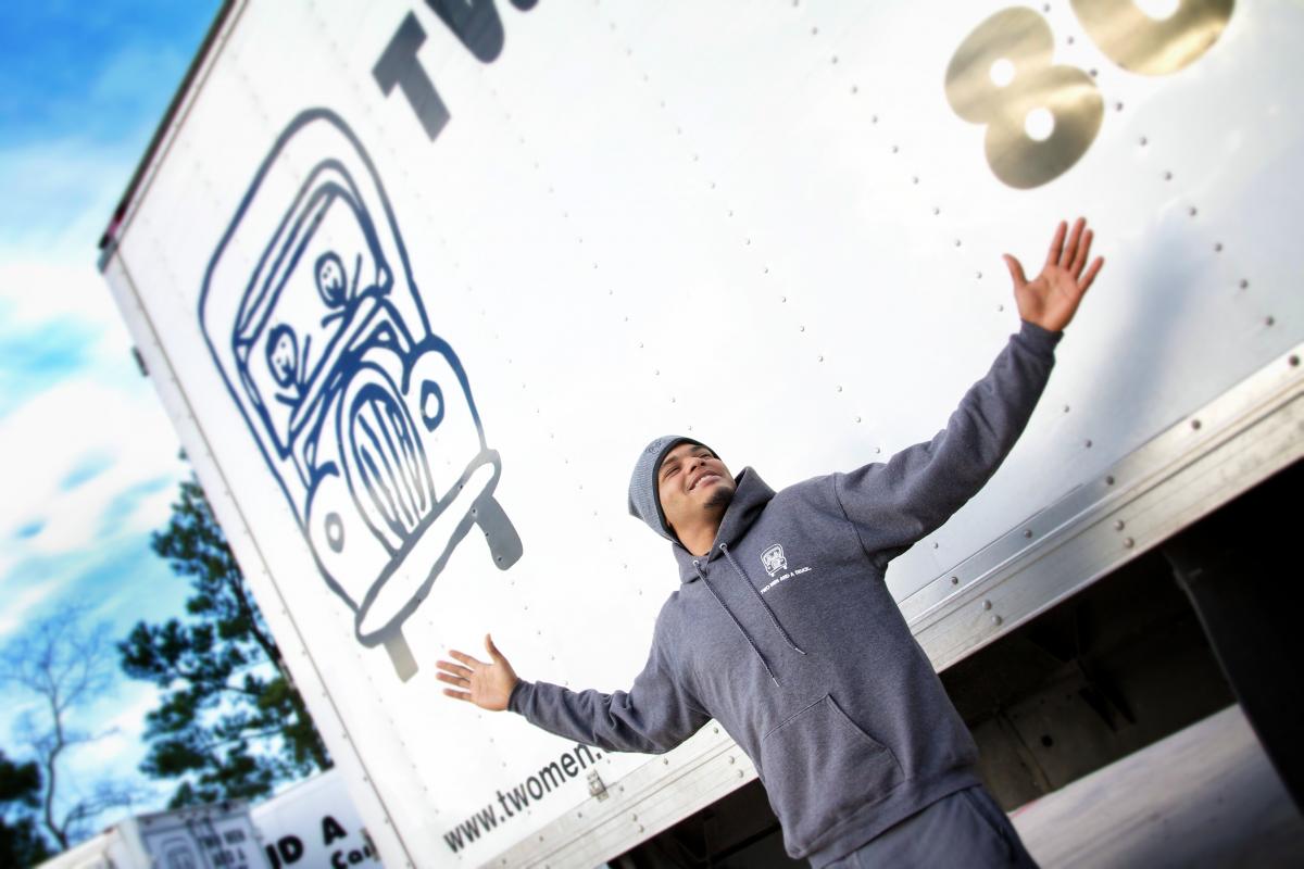Mover in front of truck with hands up