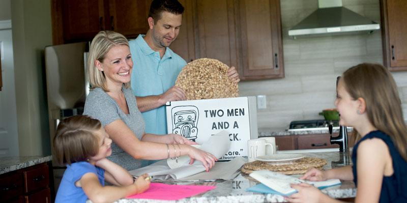 parents-with-kids-packing-up-a-kitchen.jpg Thumbnail