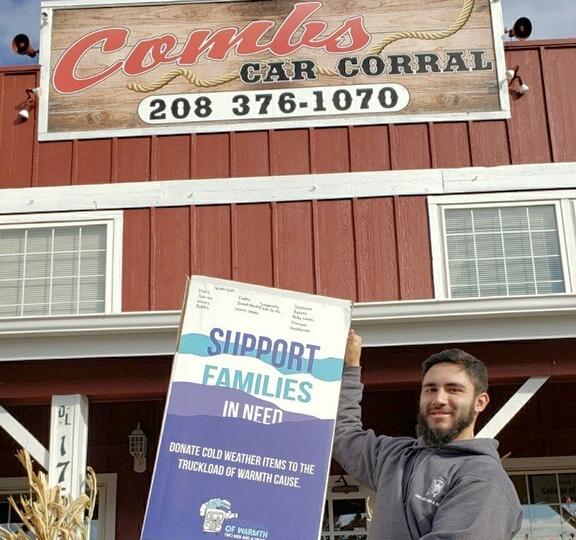 Mover holding donation box in front of Comb's Car Corral