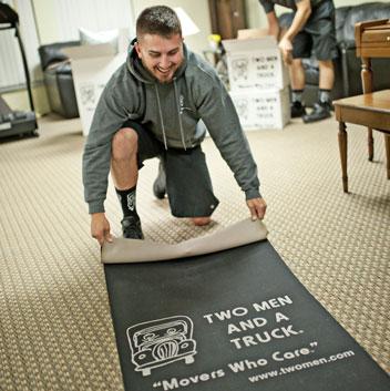 two-men-and-a-truck-mover-professionally-protecting-flooring.jpg Thumbnail