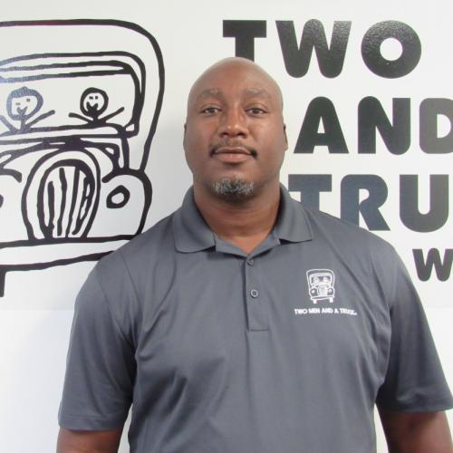 Operations Manager, Delvin Talton standing in front of out Truckie logo.