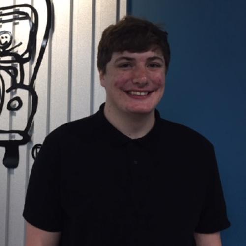 New customer service rep standing in front of our logo