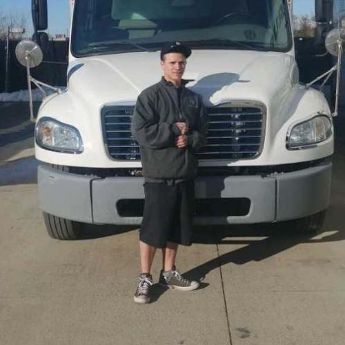 Photo of Mover of The Month Mike standing next to a moving truck