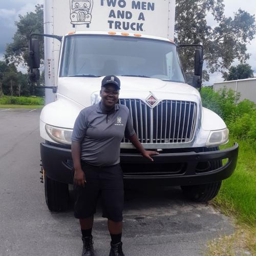 Whitney Ocala crew leader in front of our moving truck