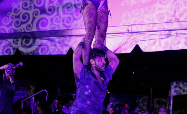 Acrobat on the shoulder of another performing at Pandemonium 25