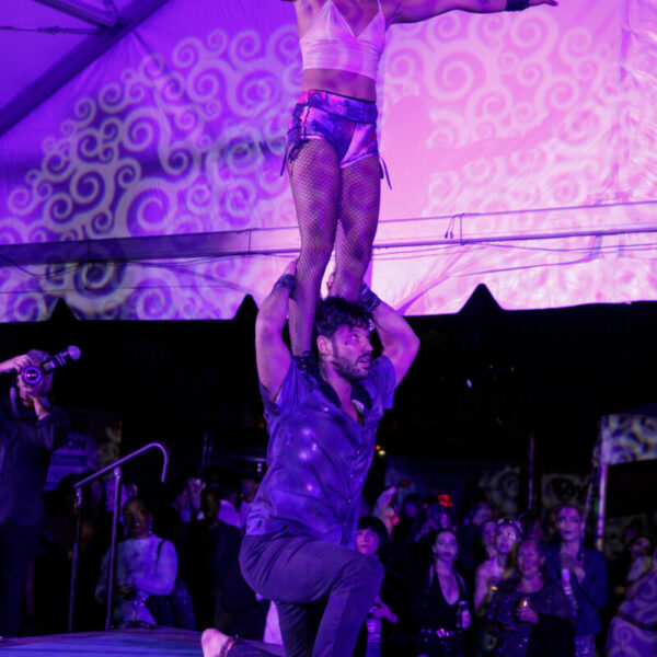 Acrobat on the shoulder of another performing at Pandemonium 25