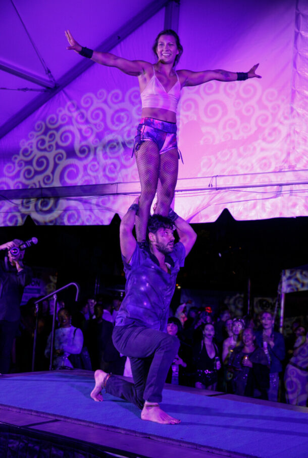Acrobat on the shoulder of another performing at Pandemonium 25
