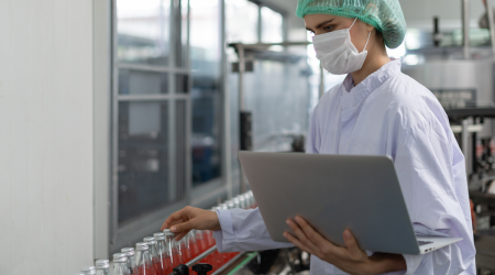 food cpg recruiters Food industry professional taking inventory on beverages in a food manufacturing facility