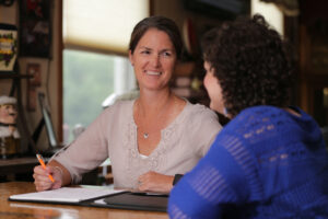 Smiling SSA meeting with a young woman about her ISP