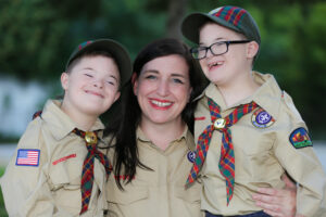 Mom, board president, and advocate Meghan Wilkinson poses with her twin boys, Casey and Connor