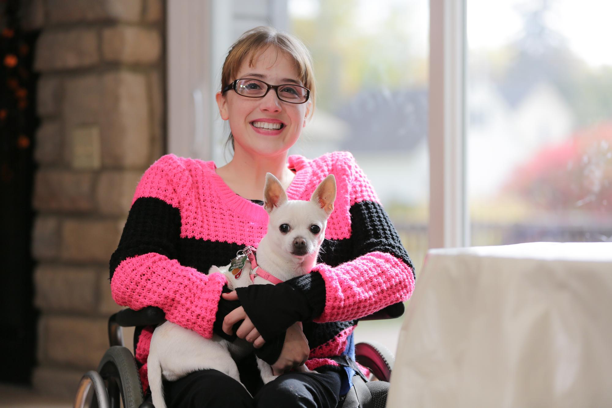 Jenna O with her dog inside her home